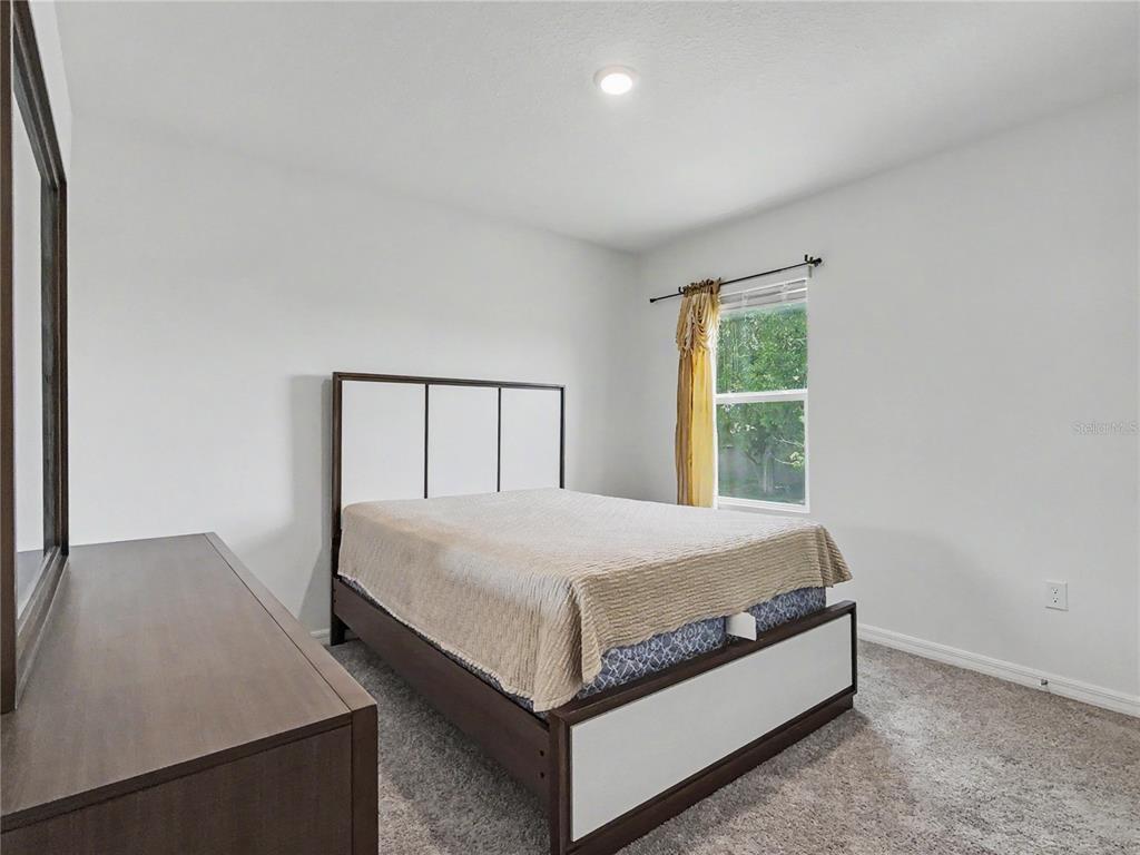 2085 Doe Run Drive Davenport, FL 33837 - Photo 35 of 44 a bed sitting in a bedroom next to a window