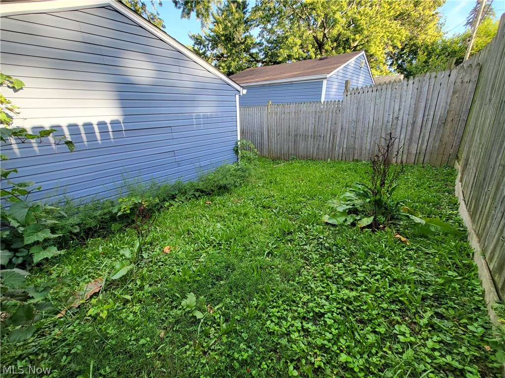 Private fenced yard behind garage