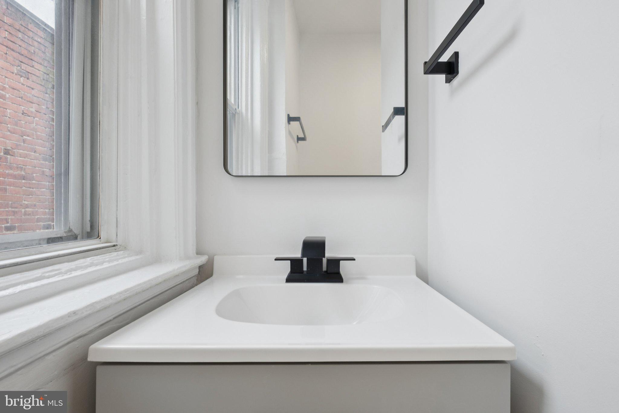 6638 Ross Street Philadelphia, PA 19119 - Photo 17 of 18 a bathroom with a sink and a mirror