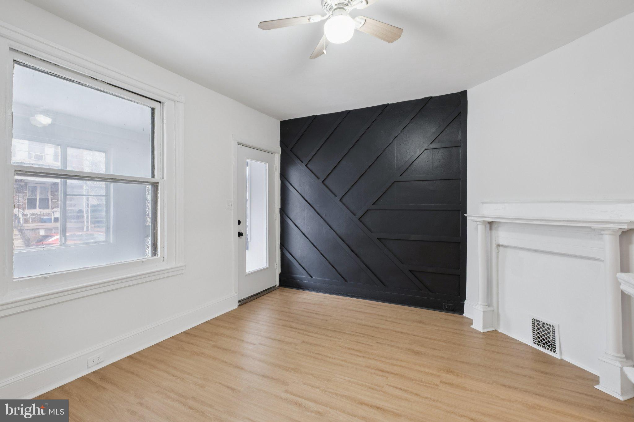 6638 Ross Street Philadelphia, PA 19119 - Photo 6 of 18 a view of an empty room with wooden floor and cabinet