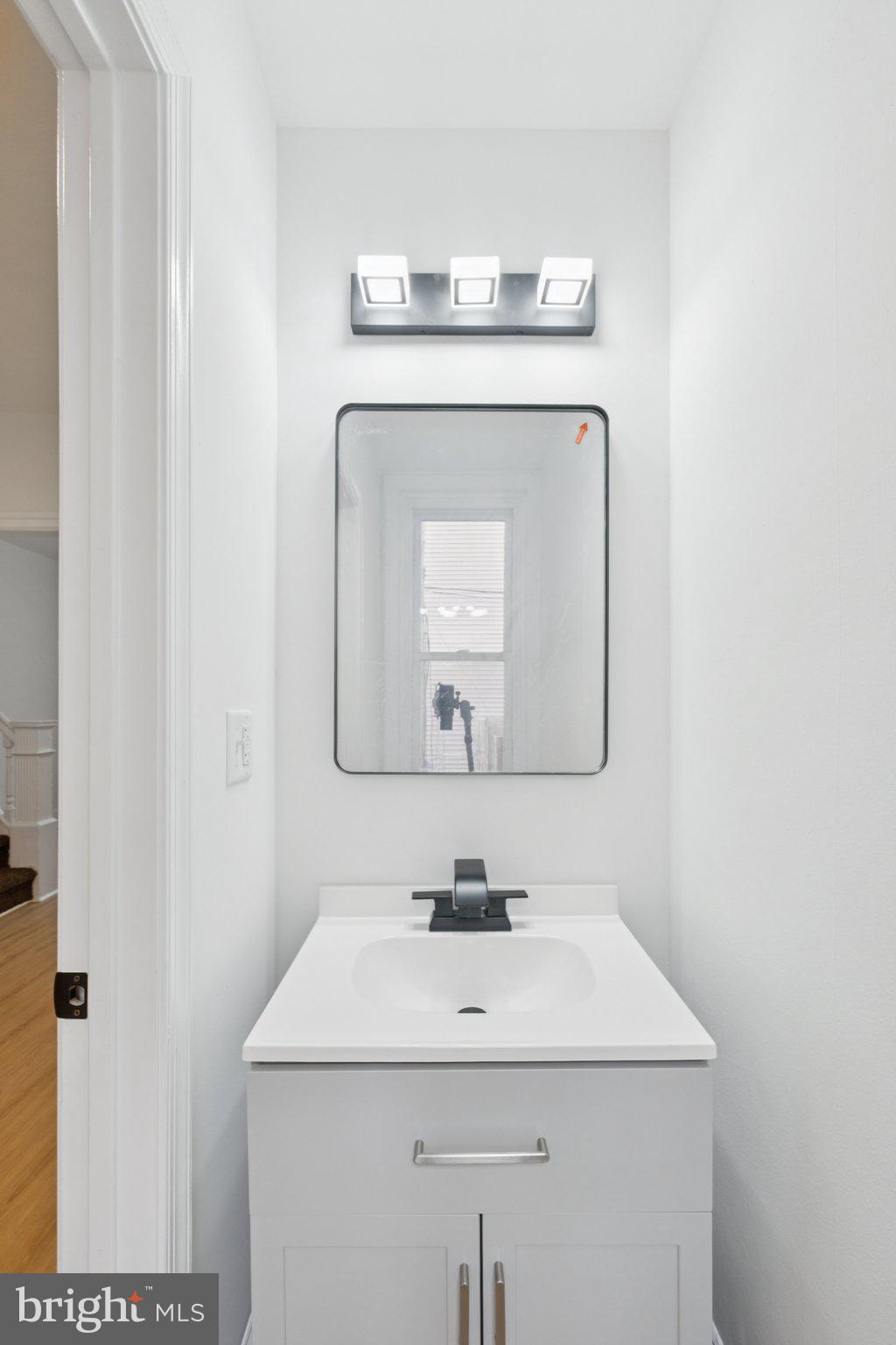 6638 Ross Street Philadelphia, PA 19119 - Photo 7 of 18 a bathroom with a sink and a mirror