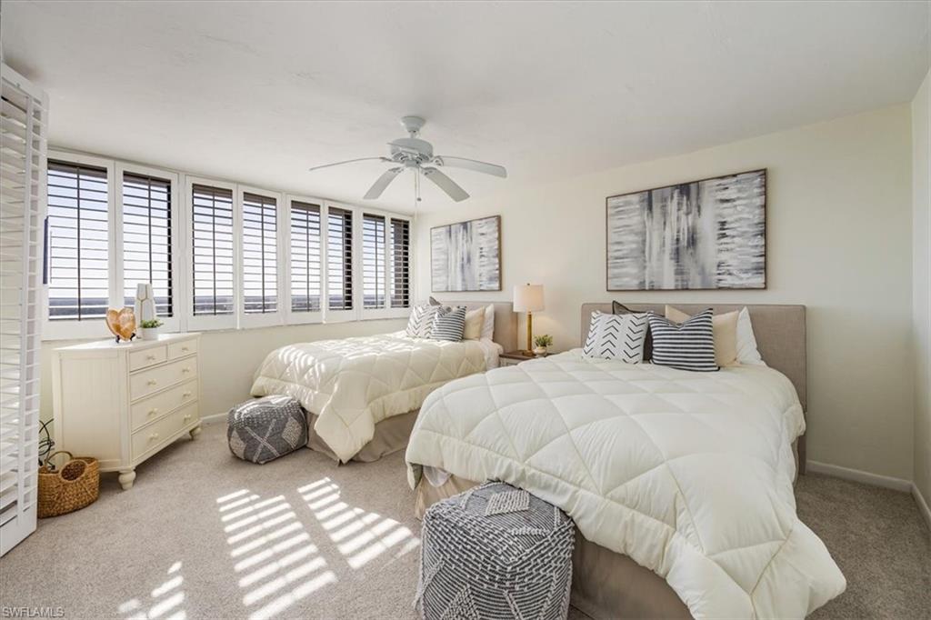 5601 Turtle Bay Drive, Unit 2003 Naples, FL 34108 - Photo 11 of 19 a spacious bedroom with two beds and a window