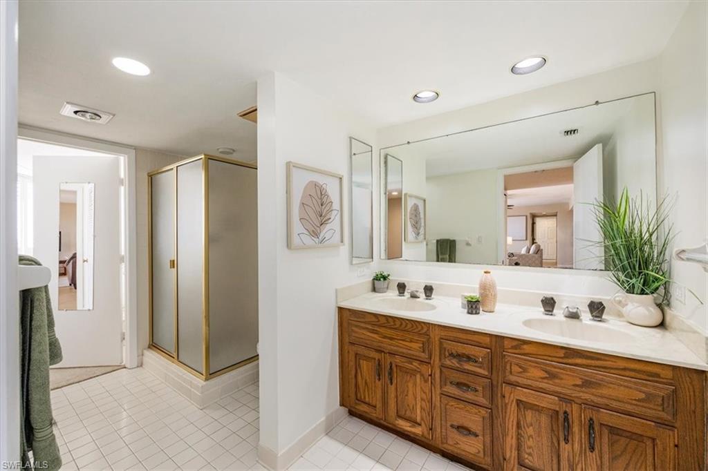 5601 Turtle Bay Drive, Unit 2003 Naples, FL 34108 - Photo 15 of 19 a spacious bathroom with a double vanity sink shower and a mirror