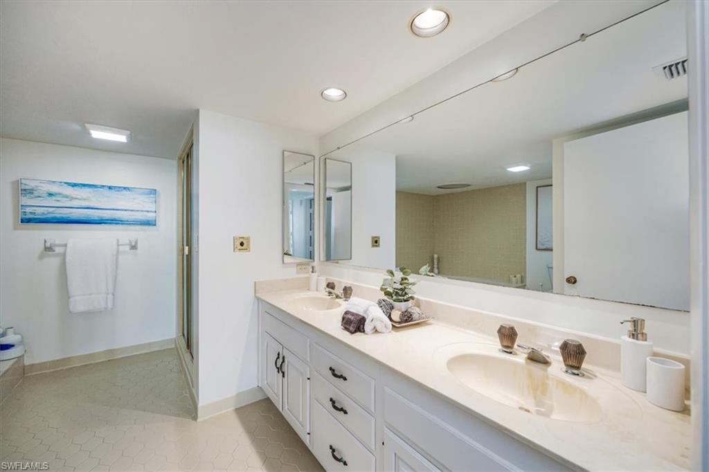 5601 Turtle Bay Drive, Unit 2003 Naples, FL 34108 - Photo 16 of 19 a spacious bathroom with a double vanity sink mirror and double