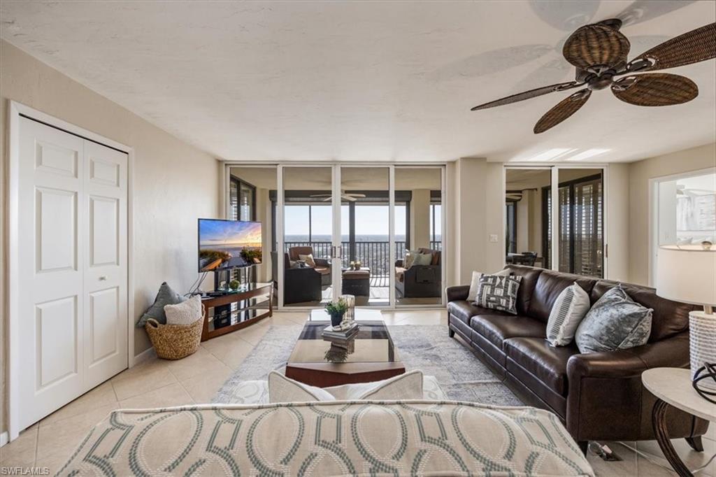 5601 Turtle Bay Drive, Unit 2003 Naples, FL 34108 - Photo 2 of 19 a living room with furniture and a large window
