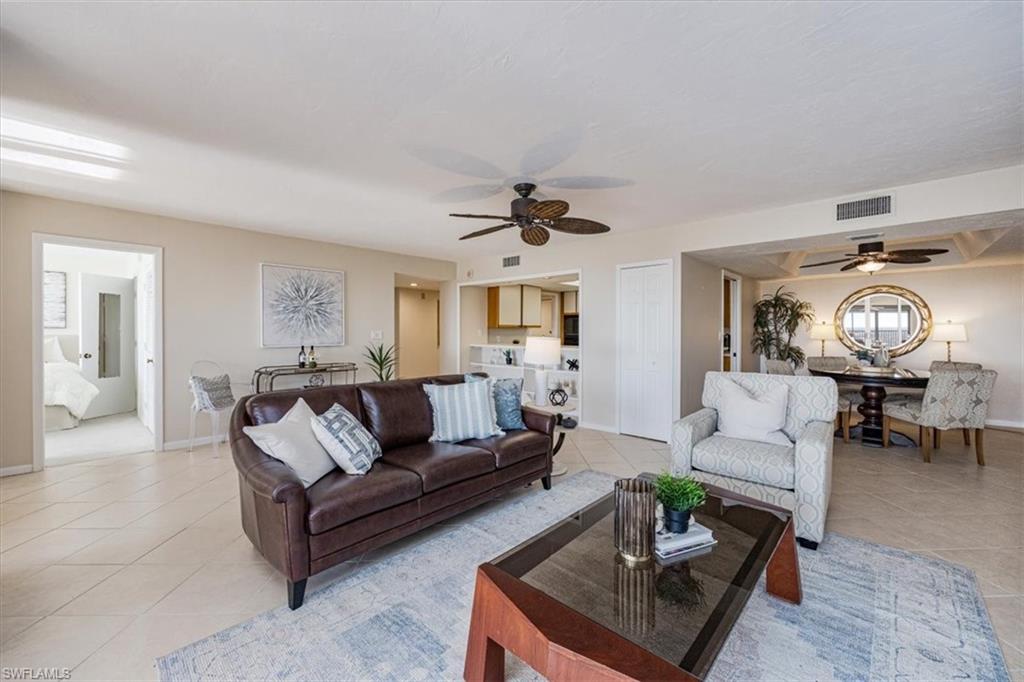 5601 Turtle Bay Drive, Unit 2003 Naples, FL 34108 - Photo 5 of 19 a living room with furniture and a chandelier