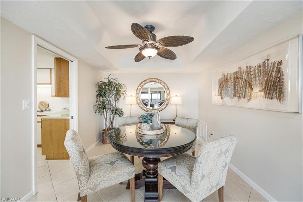 5601 Turtle Bay Drive, Unit 2003 Naples, FL 34108 - Photo 7 of 19 a view of a dining room with furniture and a chandelier fan