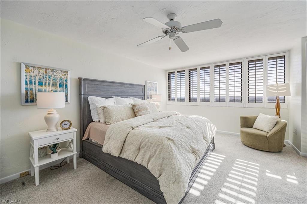 5601 Turtle Bay Drive, Unit 2003 Naples, FL 34108 - Photo 8 of 19 a spacious bedroom with a bed and a couch