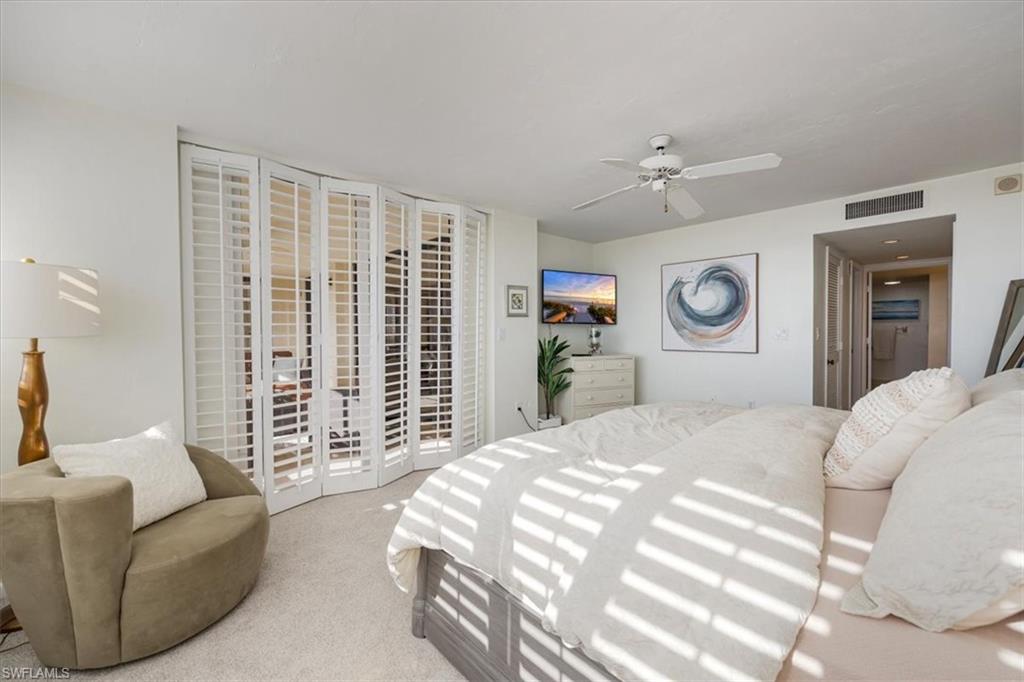 5601 Turtle Bay Drive, Unit 2003 Naples, FL 34108 - Photo 9 of 19 a bedroom with a large bed and a couch