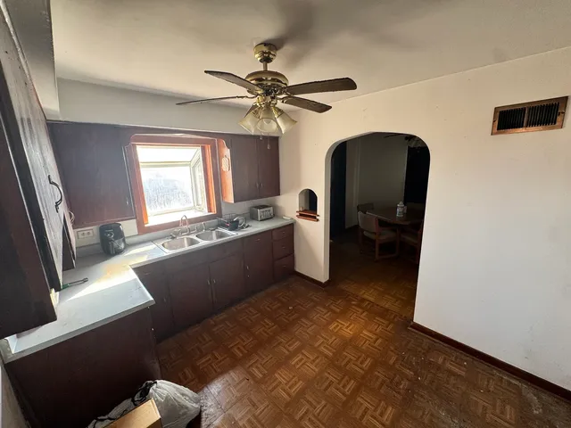 a bedroom with a bed painting and a window