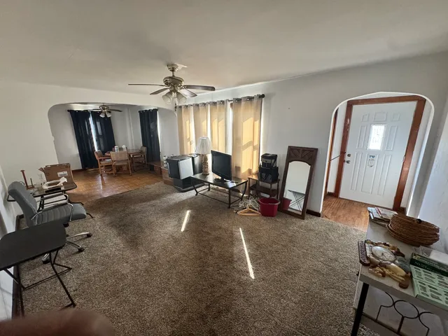 a living room with furniture and a mirror