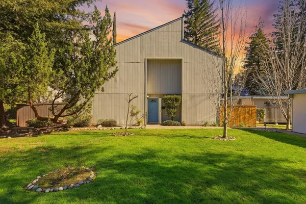 a backyard of apartments with large trees