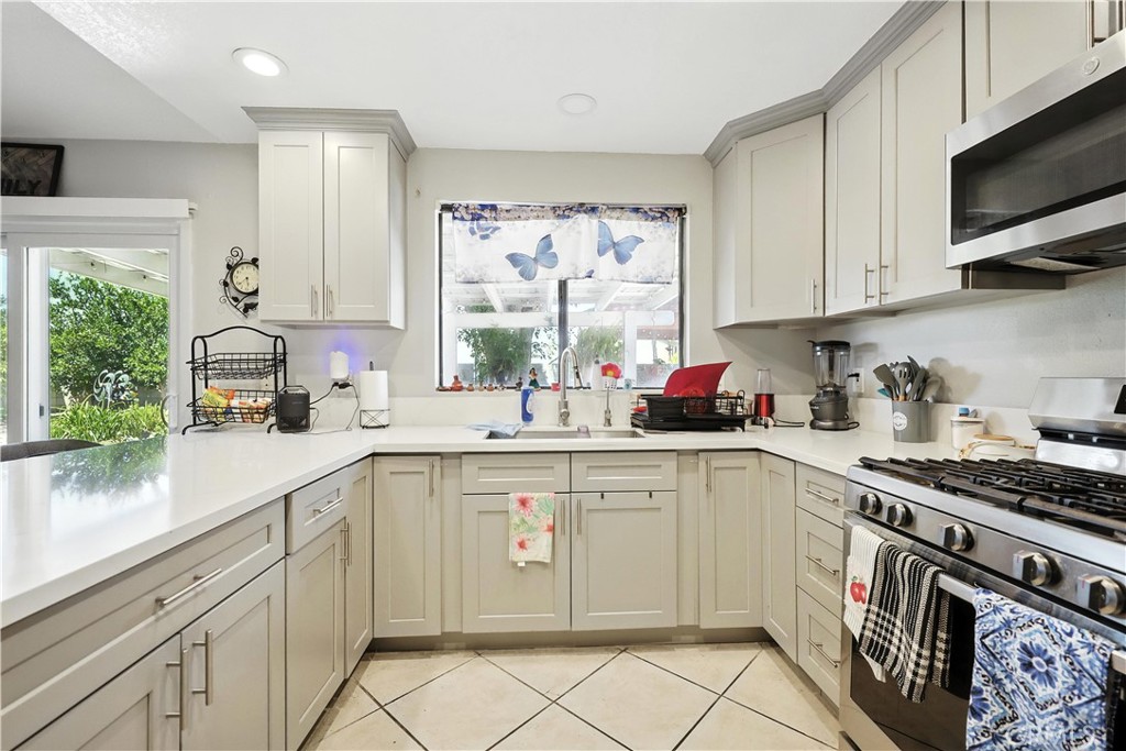 769 Harding Street Hemet, CA 92543 - Photo 11 of 29 a kitchen with cabinets appliances a sink and a window