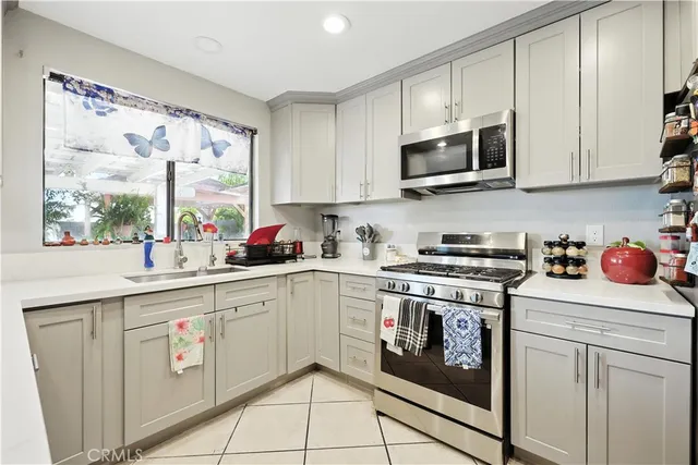 a kitchen with stainless steel appliances granite countertop a sink and a stove top oven
