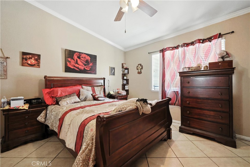 769 Harding Street Hemet, CA 92543 - Photo 15 of 29 a bedroom with a bed and a chandelier