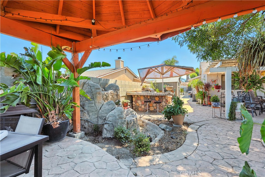 769 Harding Street Hemet, CA 92543 - Photo 26 of 29 a view of a patio with table and chairs under an umbrella