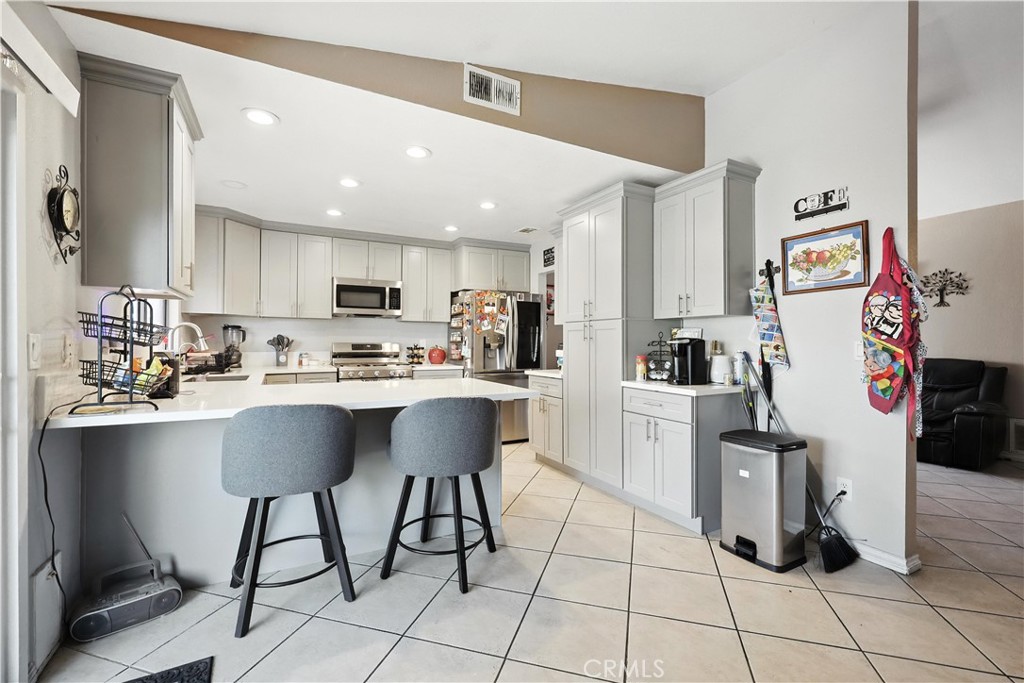 769 Harding Street Hemet, CA 92543 - Photo 9 of 29 a kitchen with granite countertop a sink cabinets and stainless steel appliances