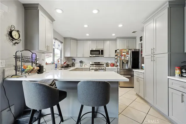 a kitchen with stainless steel appliances a sink stove and refrigerator