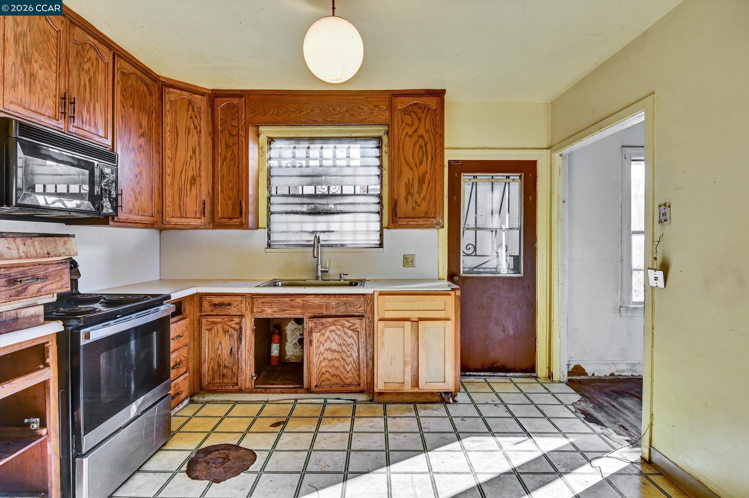 1711 Carleton Street Berkeley, CA 94703 - Photo 11 of 40 a kitchen with stainless steel appliances granite countertop a stove a sink and a refrigerator