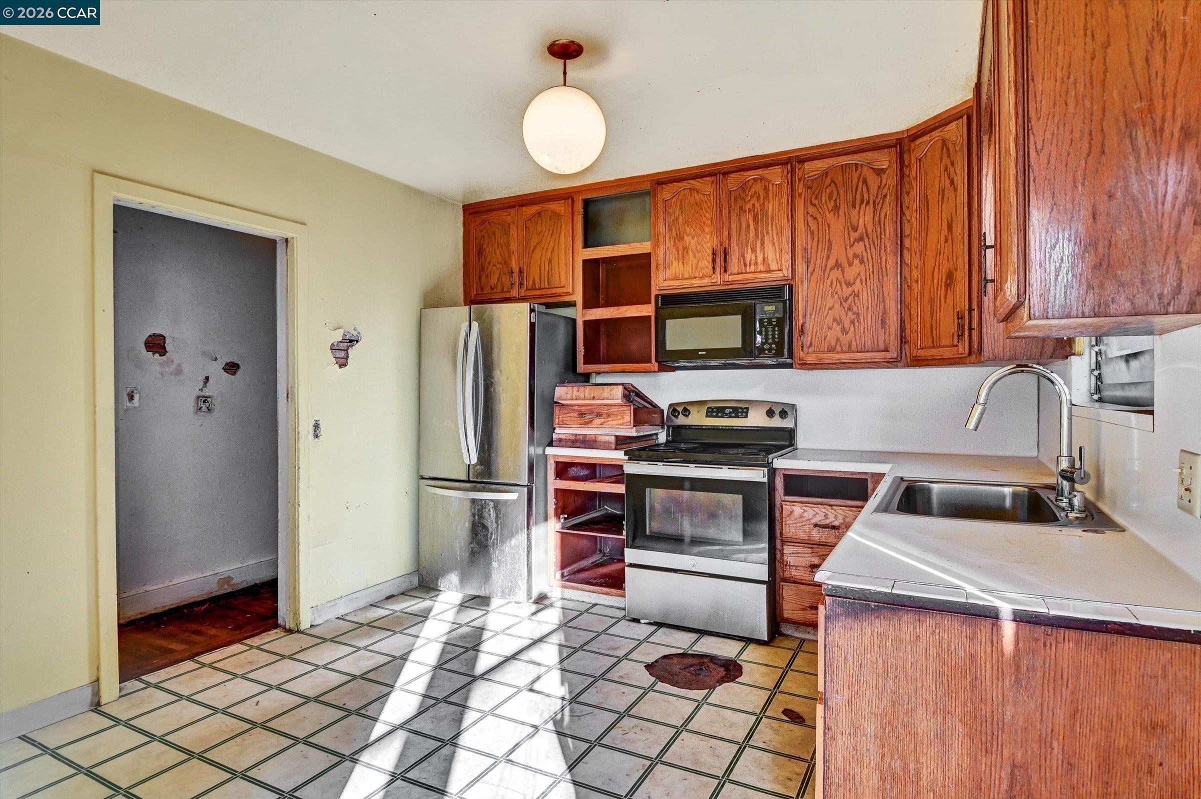 1711 Carleton Street Berkeley, CA 94703 - Photo 9 of 40 a kitchen with stainless steel appliances granite countertop a refrigerator stove and sink