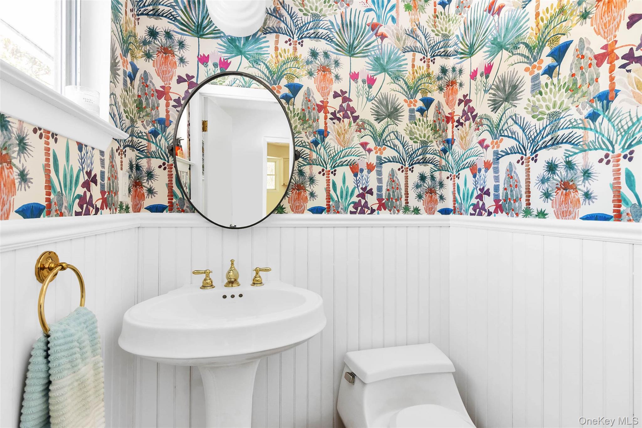 485 Pine Road Southold, NY 11971 - Photo 16 of 39 a bathroom with a sink and mirror with toilet