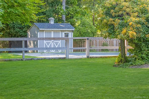 a front view of a house with a yard and a garden