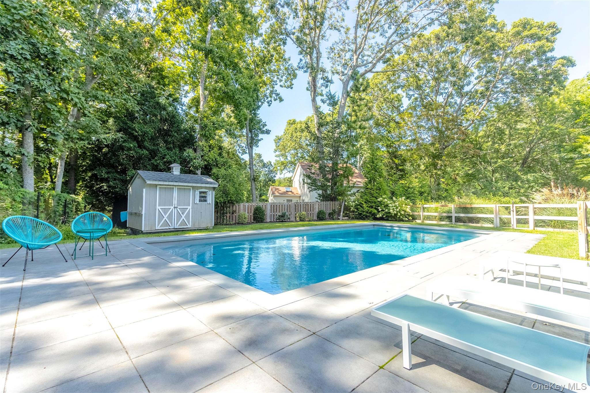 485 Pine Road Southold, NY 11971 - Photo 21 of 39 a view of a swimming pool with a lounge chairs