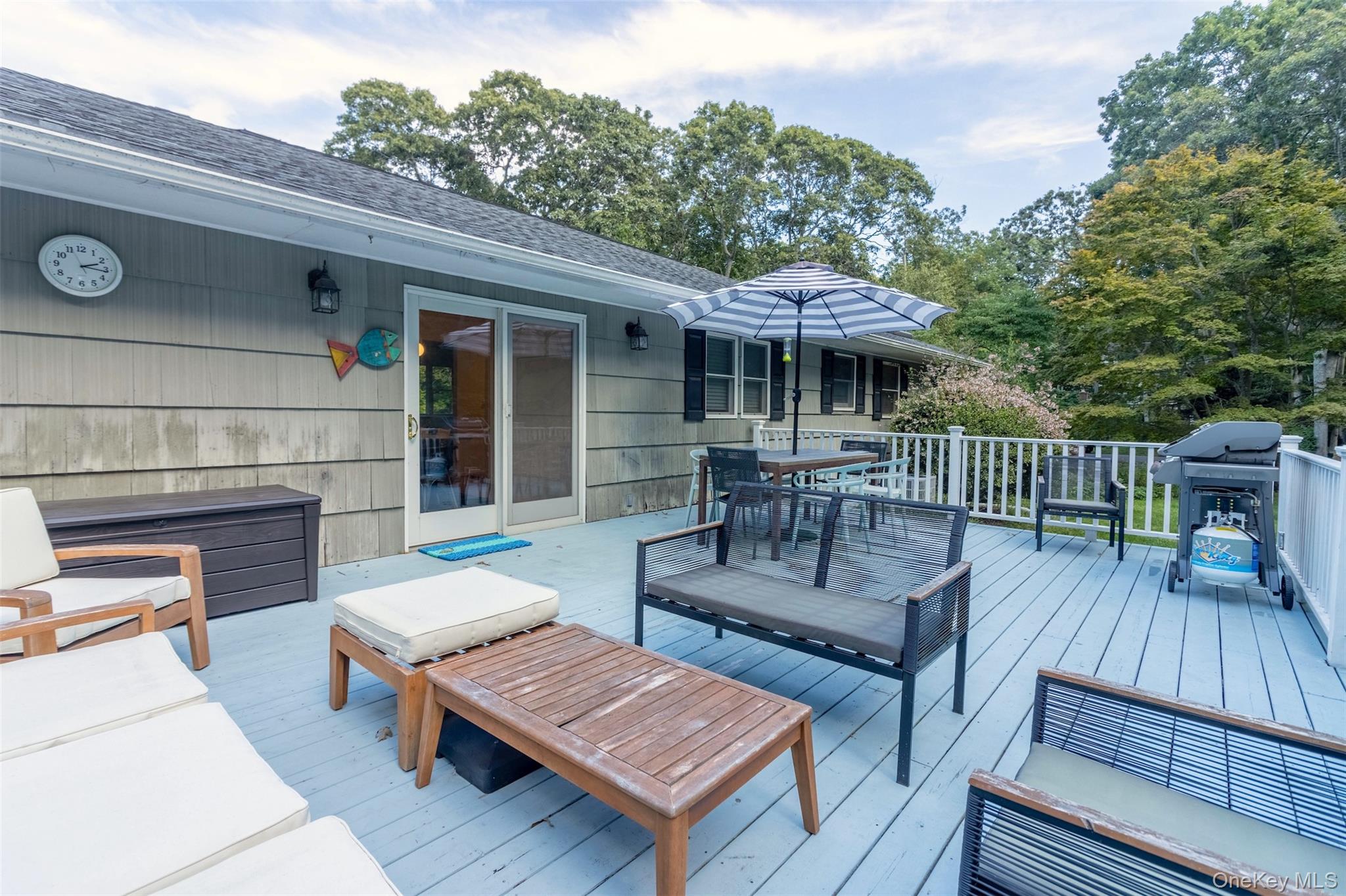 485 Pine Road Southold, NY 11971 - Photo 22 of 39 an outdoor space with patio the couches and a dining table with garden view