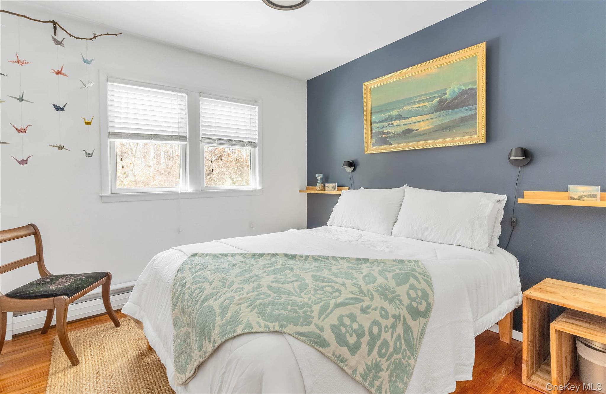 485 Pine Road Southold, NY 11971 - Photo 26 of 39 a bedroom with a bed and wooden floor