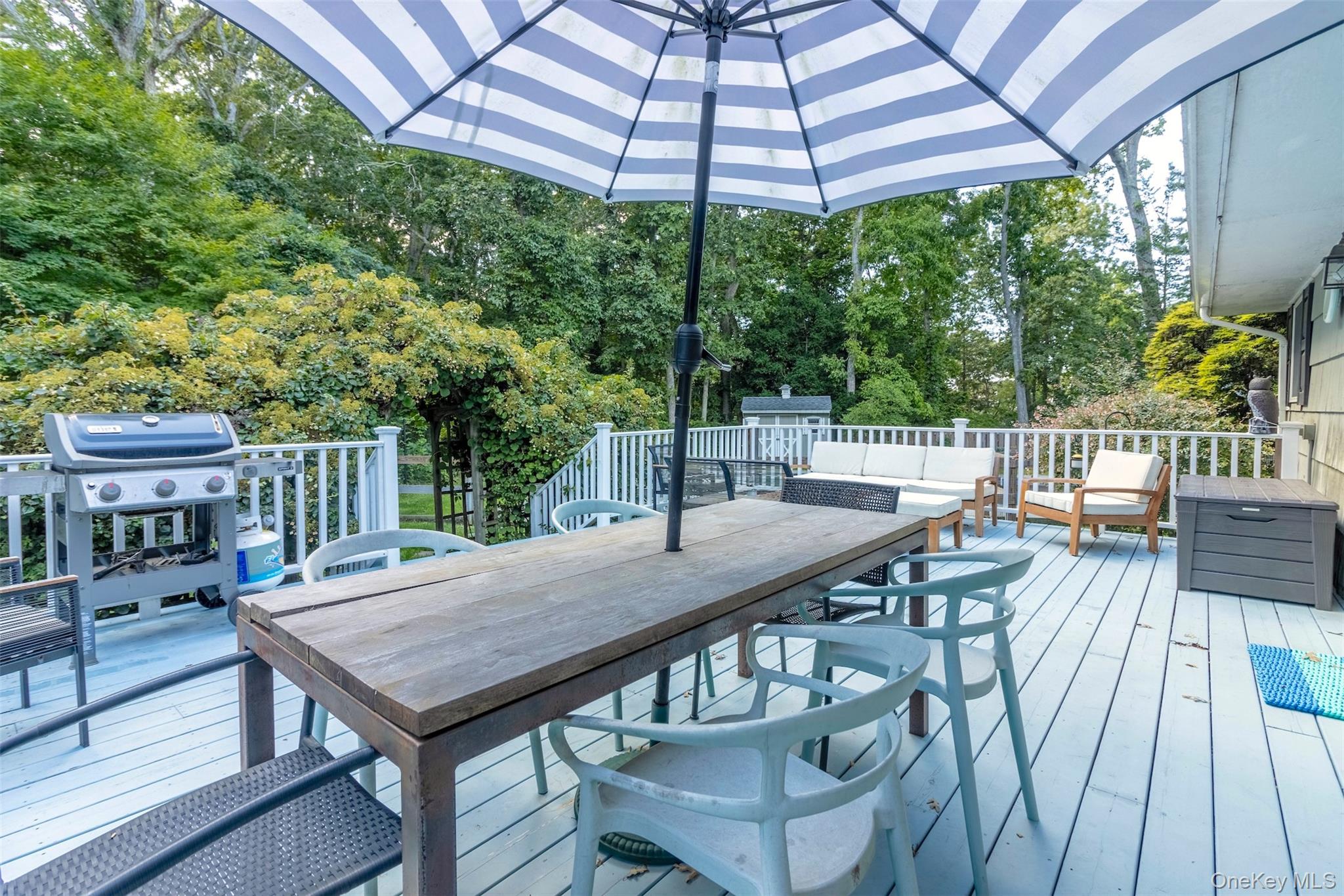 485 Pine Road Southold, NY 11971 - Photo 30 of 39 a view of a patio with table and chairs under an umbrella with wooden floor