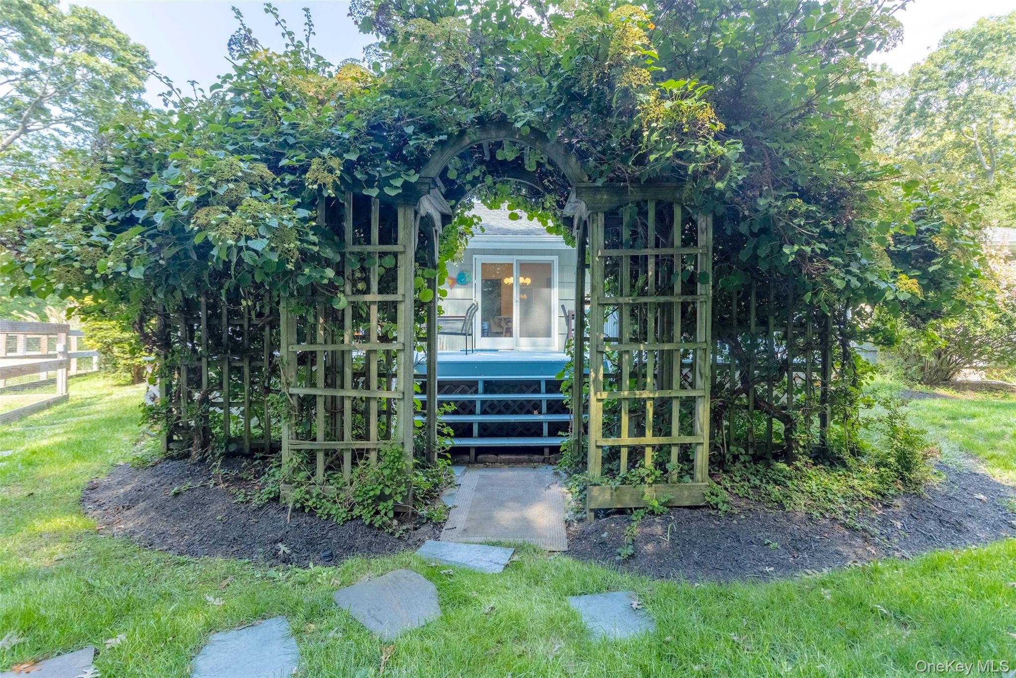 485 Pine Road Southold, NY 11971 - Photo 32 of 39 a front view of a house with a garden