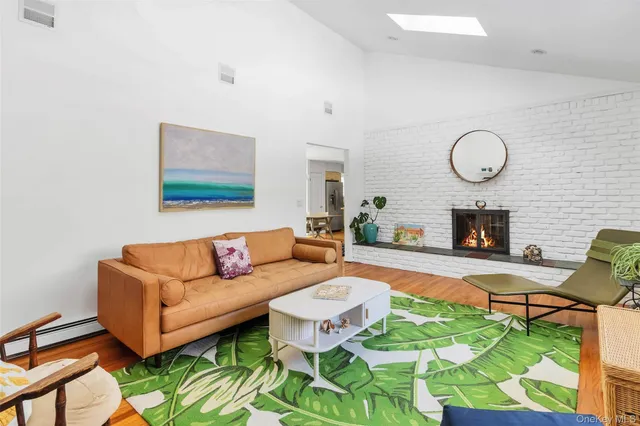 a living room with furniture a fireplace and a table