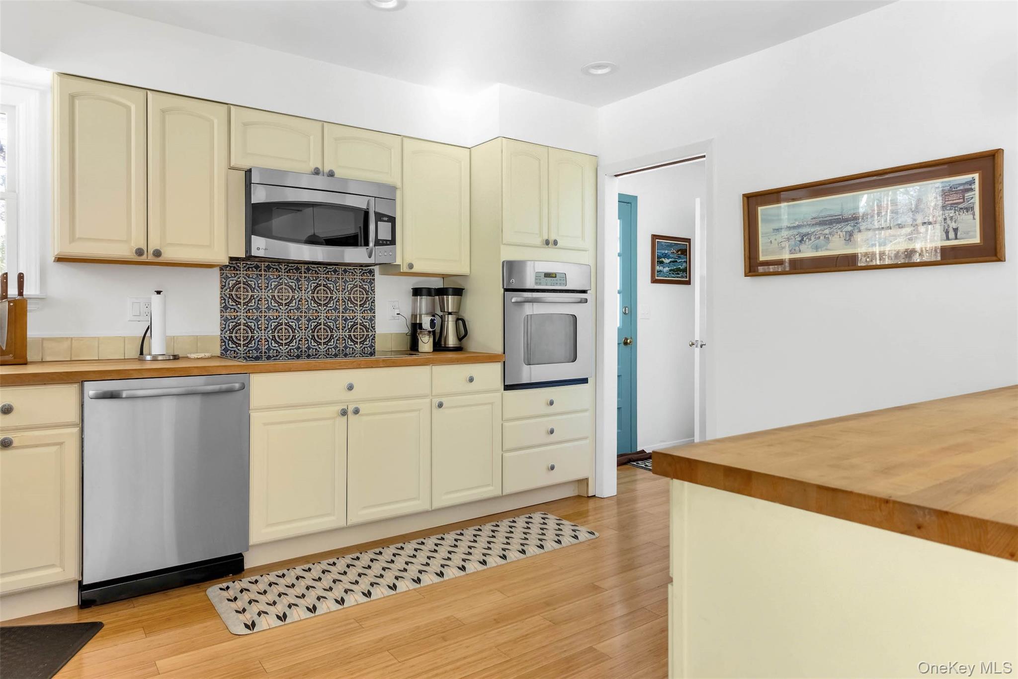 485 Pine Road Southold, NY 11971 - Photo 9 of 39 a kitchen with stainless steel appliances a refrigerator sink and microwave