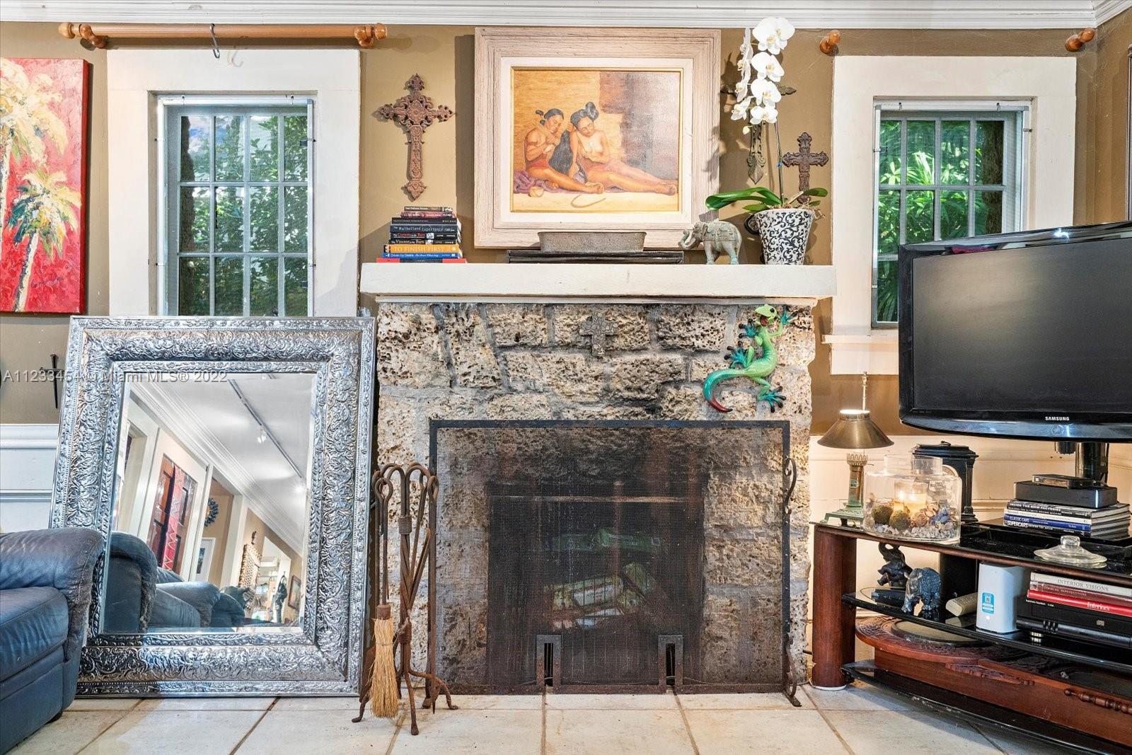 3041 Oak Avenue Coconut Grove, FL 33133 - Photo 11 of 31 a living room with a fireplace and a flat screen tv