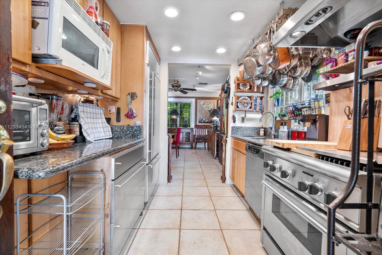 3041 Oak Avenue Coconut Grove, FL 33133 - Photo 12 of 31 a kitchen with stainless steel appliances granite countertop a stove and a sink