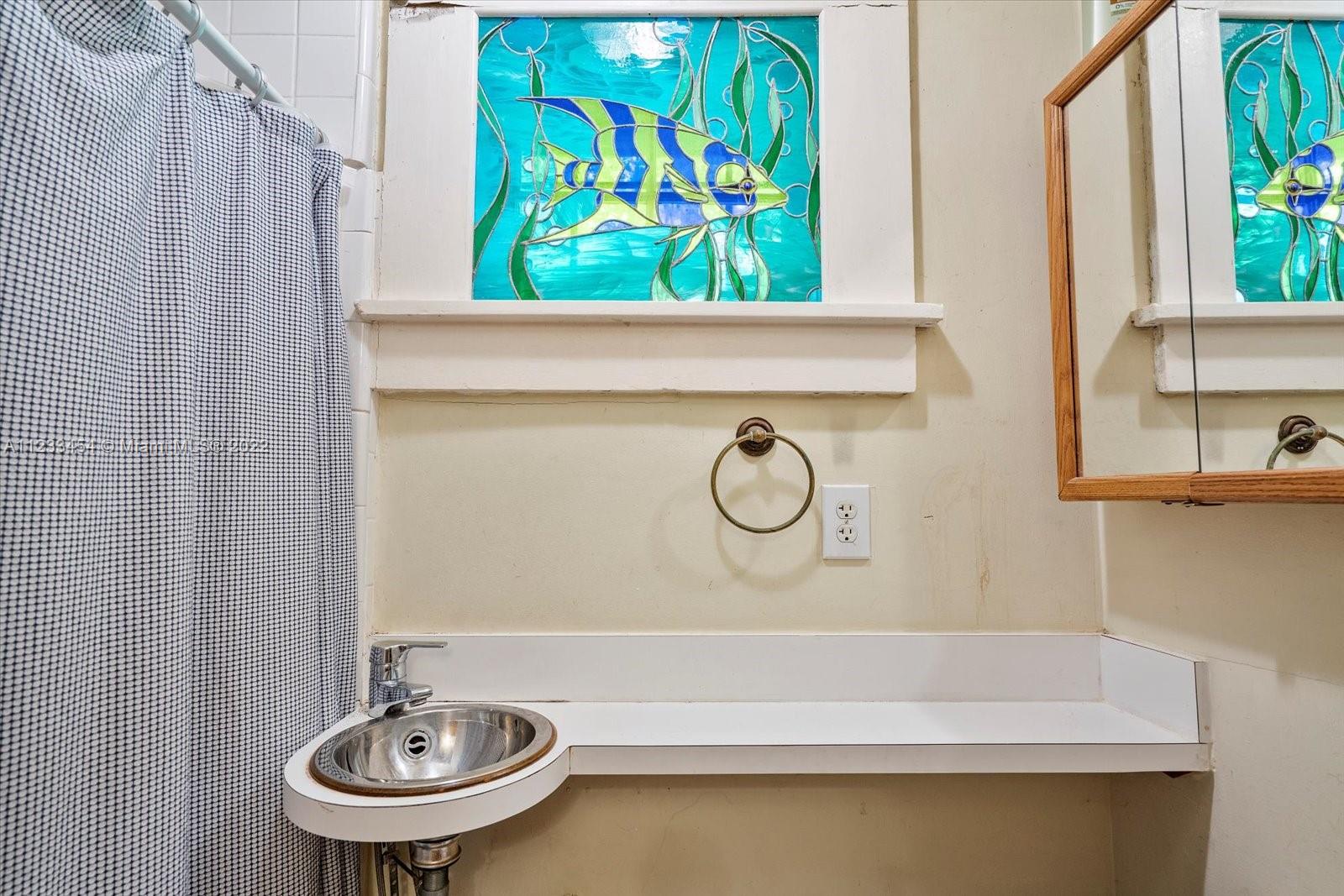 3041 Oak Avenue Coconut Grove, FL 33133 - Photo 17 of 31 a bathroom with a sink and a mirror