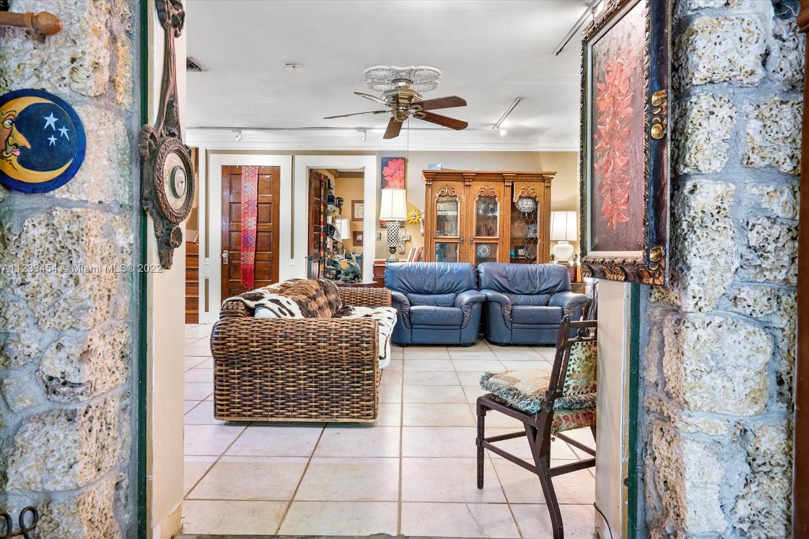 3041 Oak Avenue Coconut Grove, FL 33133 - Photo 4 of 31 a living room with furniture a fireplace and a floor to ceiling window