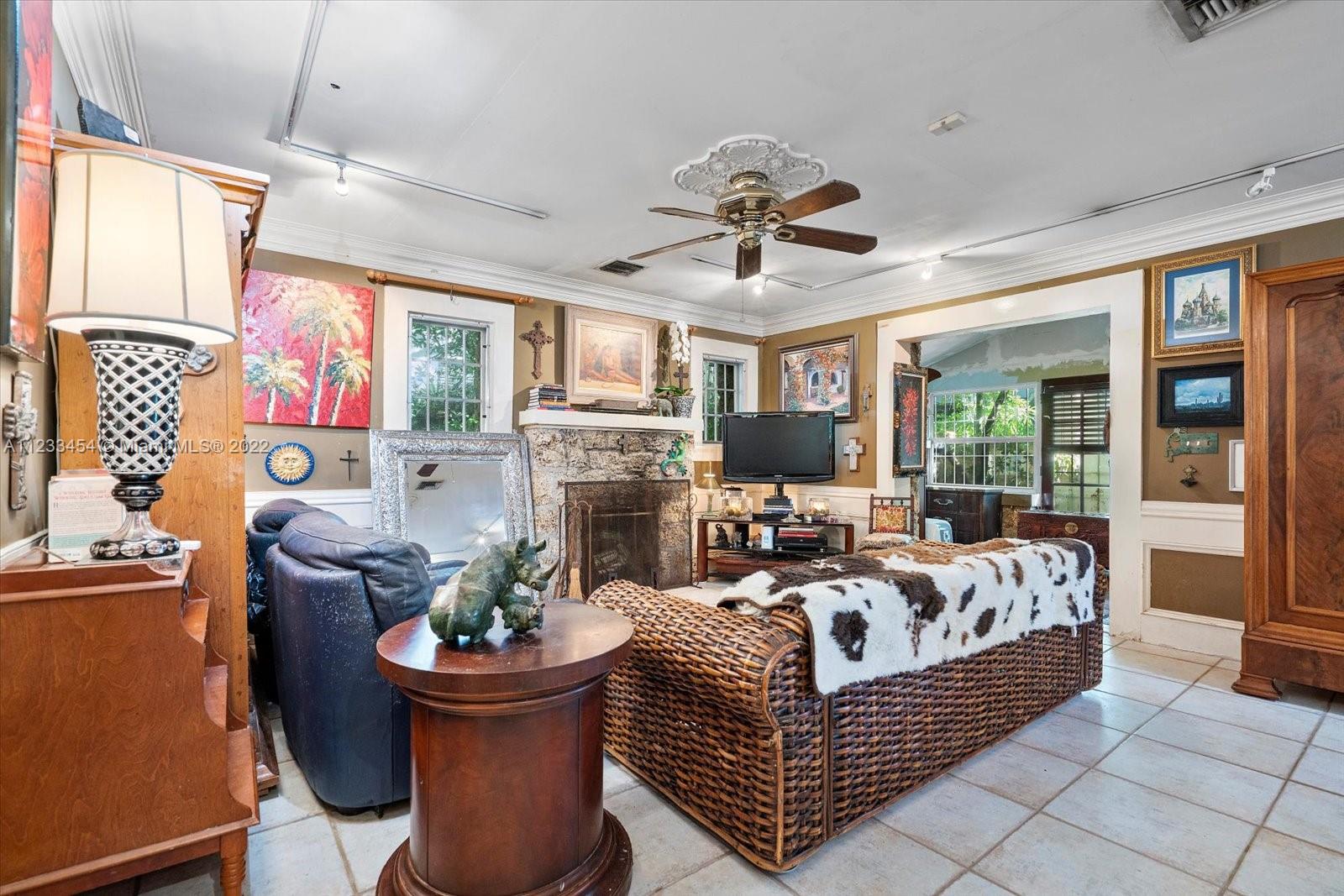 3041 Oak Avenue Coconut Grove, FL 33133 - Photo 5 of 31 a living room with furniture a fireplace and a chandelier