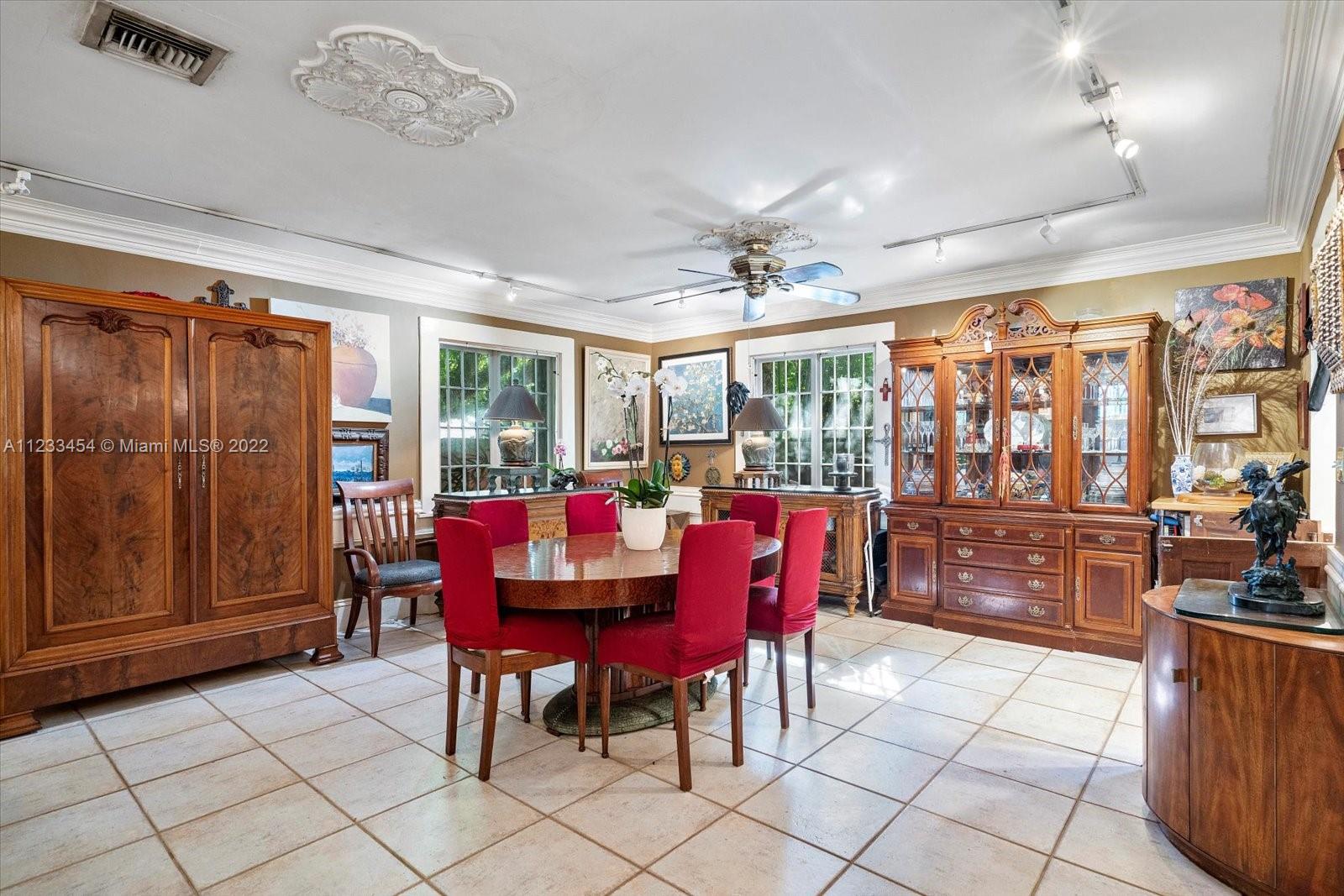3041 Oak Avenue Coconut Grove, FL 33133 - Photo 9 of 31 a view of a dining room with furniture a chandelier and window