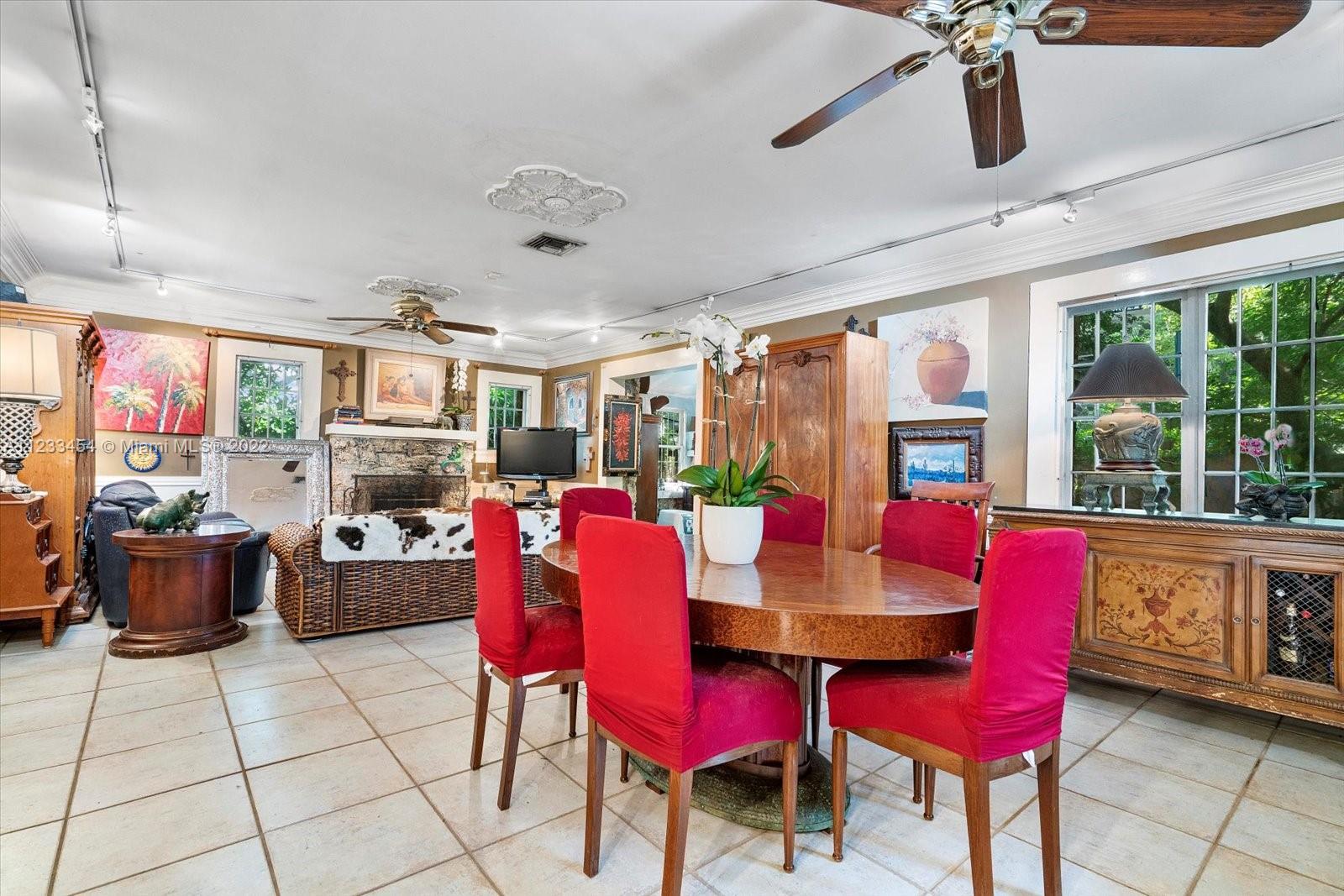 3041 Oak Avenue Coconut Grove, FL 33133 - Photo 10 of 31 a dining room with a wooden table and chairs