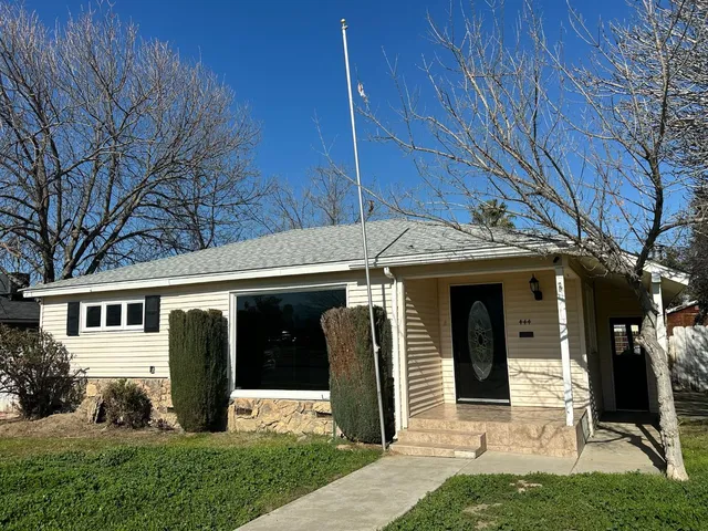 a view of a front door and small yard