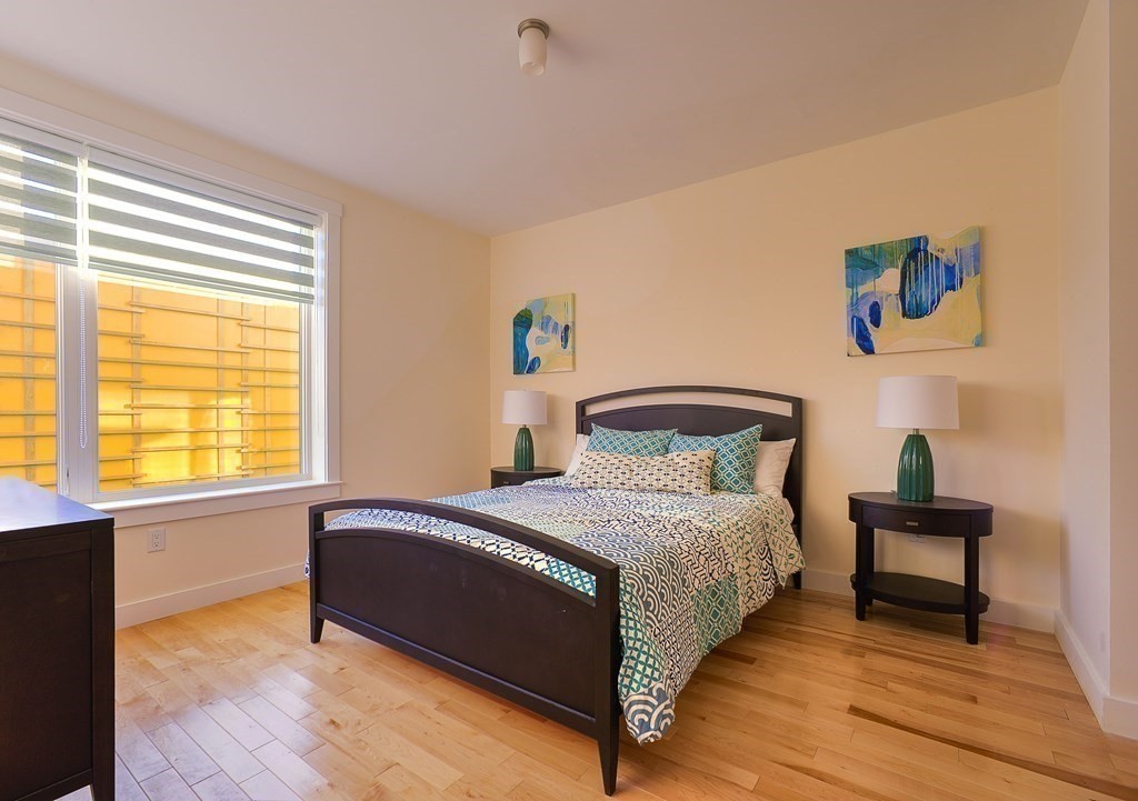 603 Concord, Unit 311 Cambridge, MA 02138 - Photo 5 of 11 a bedroom with a bed and a potted plant on a dresser