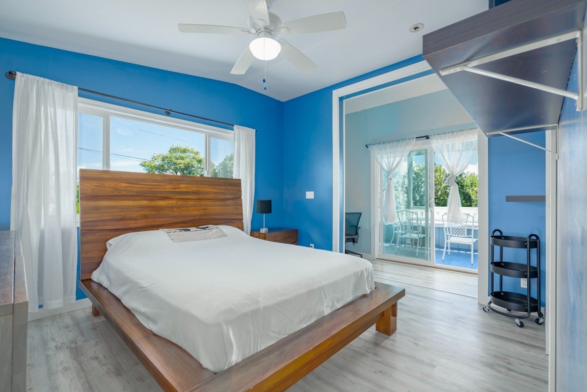 27-571 Kalaoa Camp Road Papaikou, HI 96781 - Photo 17 of 29 a bed sitting in a spacious bedroom next to a window