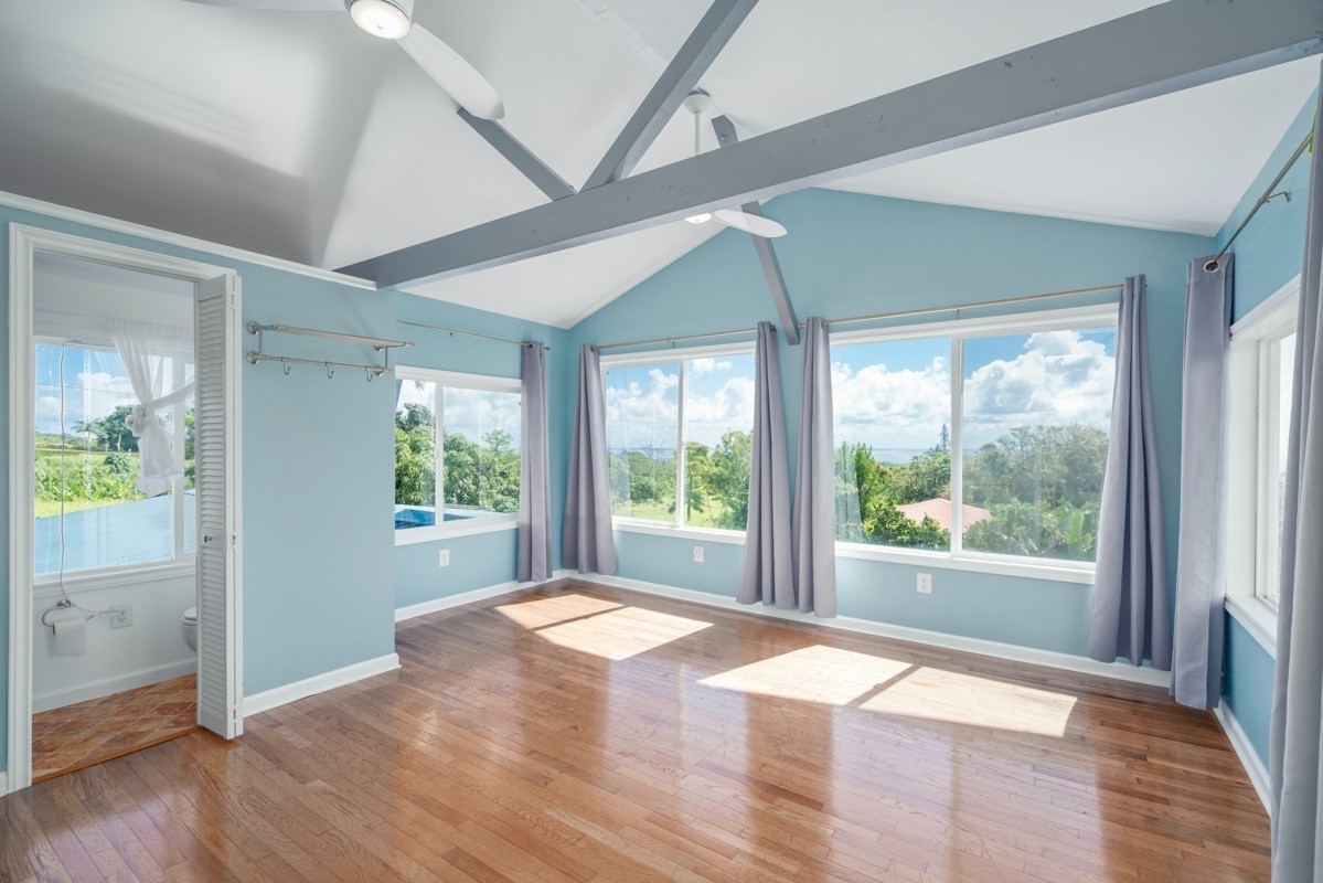 27-571 Kalaoa Camp Road Papaikou, HI 96781 - Photo 25 of 29 a view of an empty room with wooden floor and a window