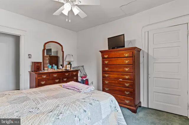 a bedroom with a bed and a television