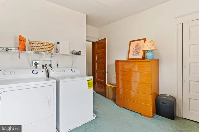 a utility room with fridge dryer and washer