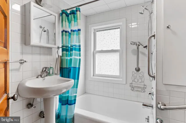 a bathroom with a sink a mirror and a bathtub