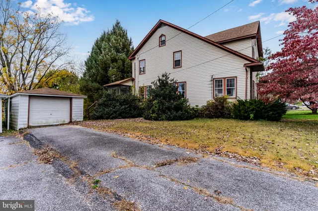 a view of backyard of house and green space