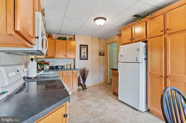 a kitchen with refrigerator and window