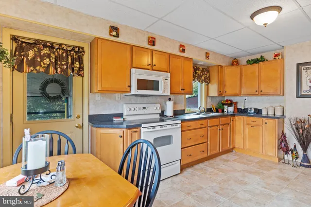 a kitchen with stainless steel appliances granite countertop a stove a sink dishwasher and a refrigerator